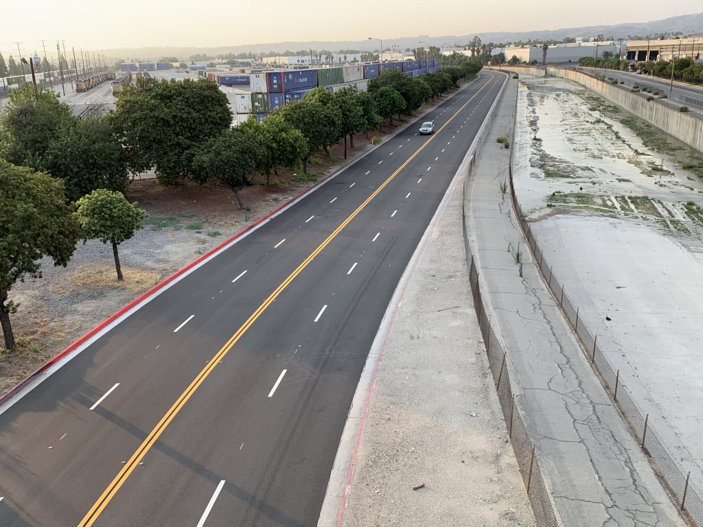 Empty road beside a riverbank
