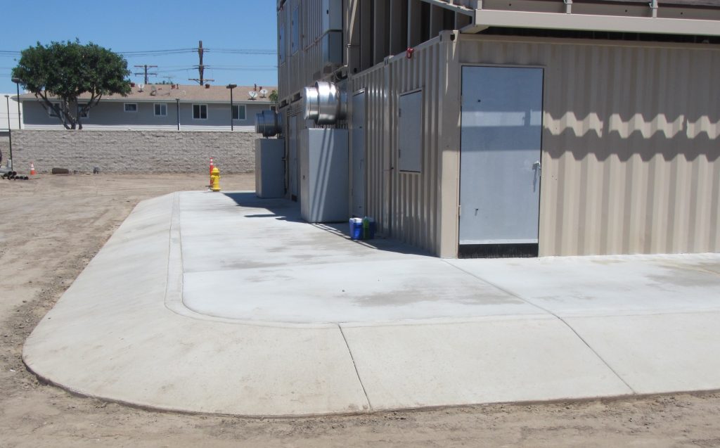 Concrete pathway by metal building